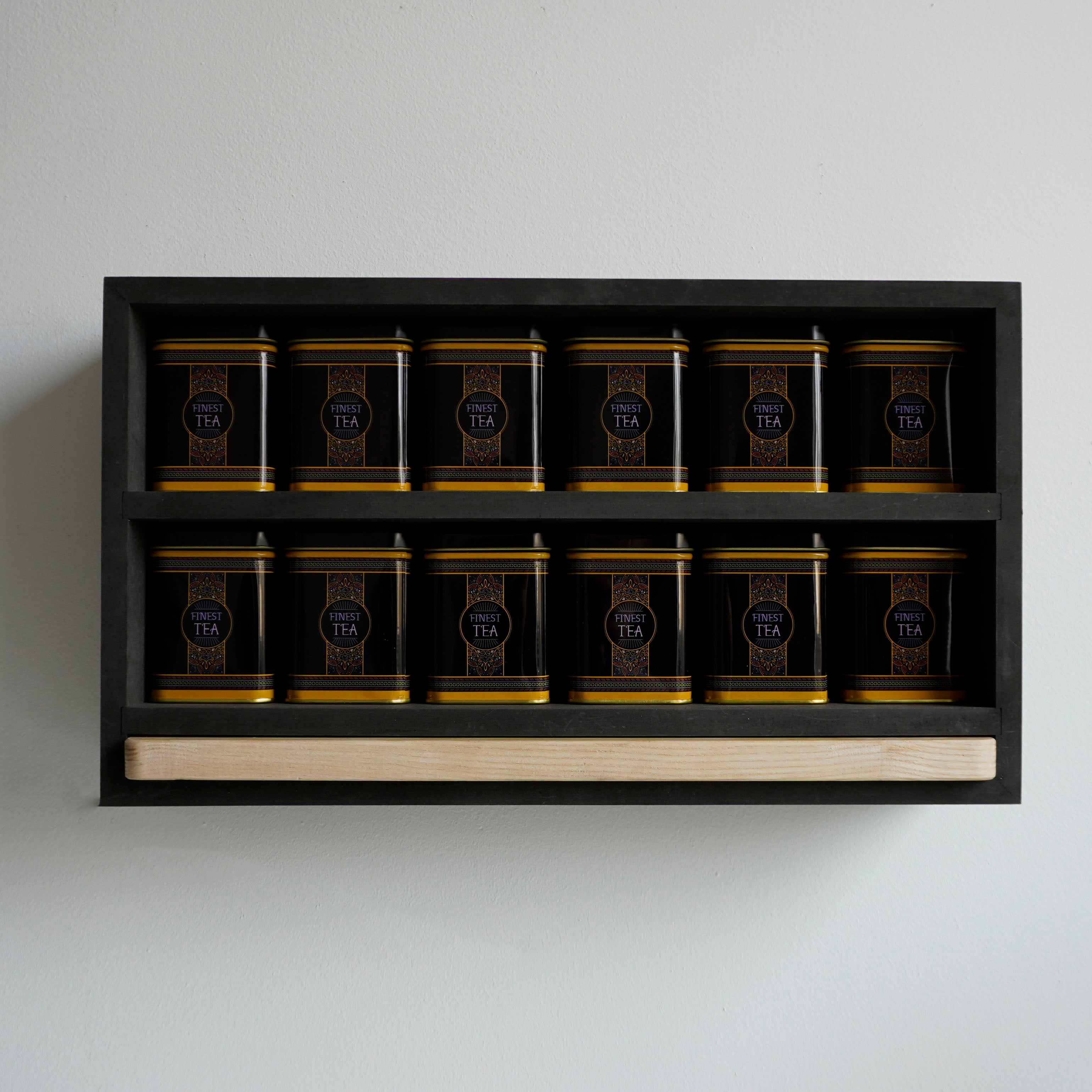 Vooraanzicht van een theerek met finest tea blikken en berken serveerplank
